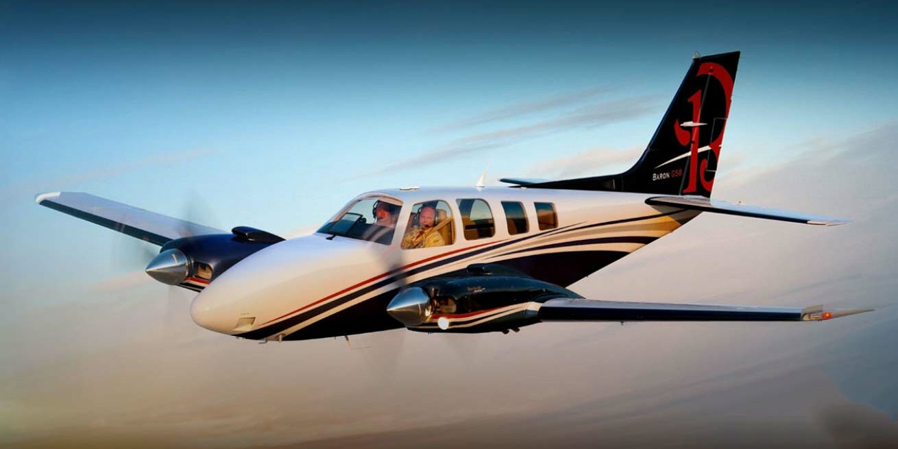 red white blue beechcraft baron in flight